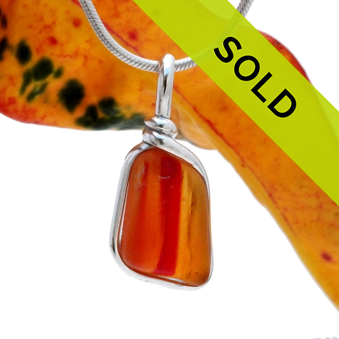 A once in a lifetime piece of large ORANGE art sea glass is set in our Original Wire Bezel© pendant setting.