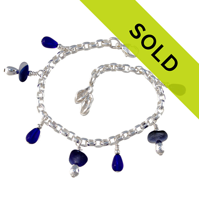 3 pieces of genuine beach found sea glass in a flashed blue and white combined with bright blue fire polished cobalt beads in a totally solid sterling silver bracelet.