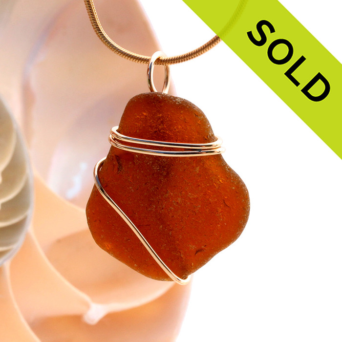 A neat top quality piece of beach found Amber Brown Genuine Sea Glass in a simple wire wrapped gold pendant setting.
Sorry this Sea Glass Jewelry selection has been SOLD!