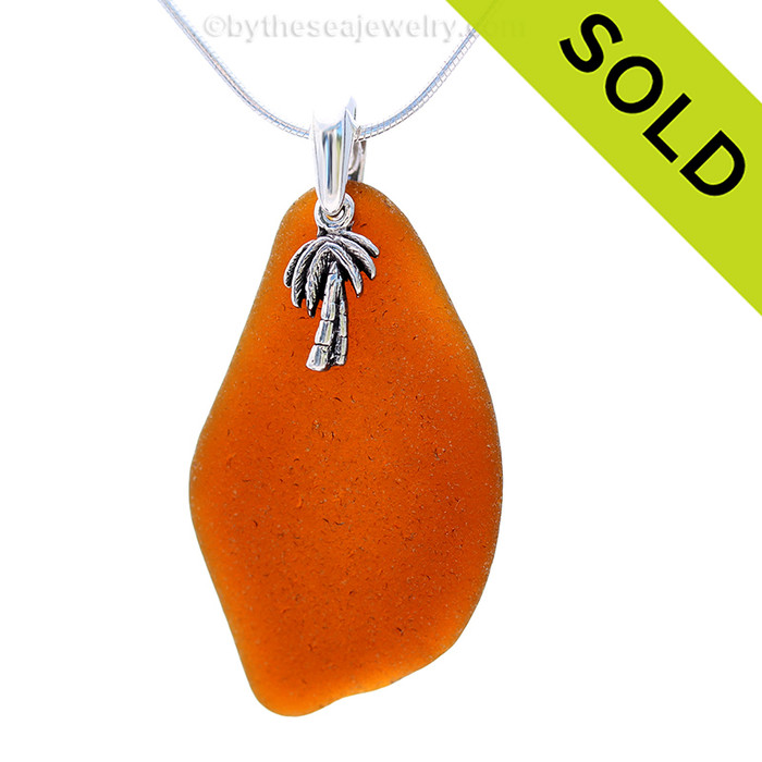 Beach found bright amber sea glass is combined with a solid sterling Palm tree and presented on an 18 Inch solid sterling snake chain.
Sorry this Sea Glass Necklace has been SOLD!