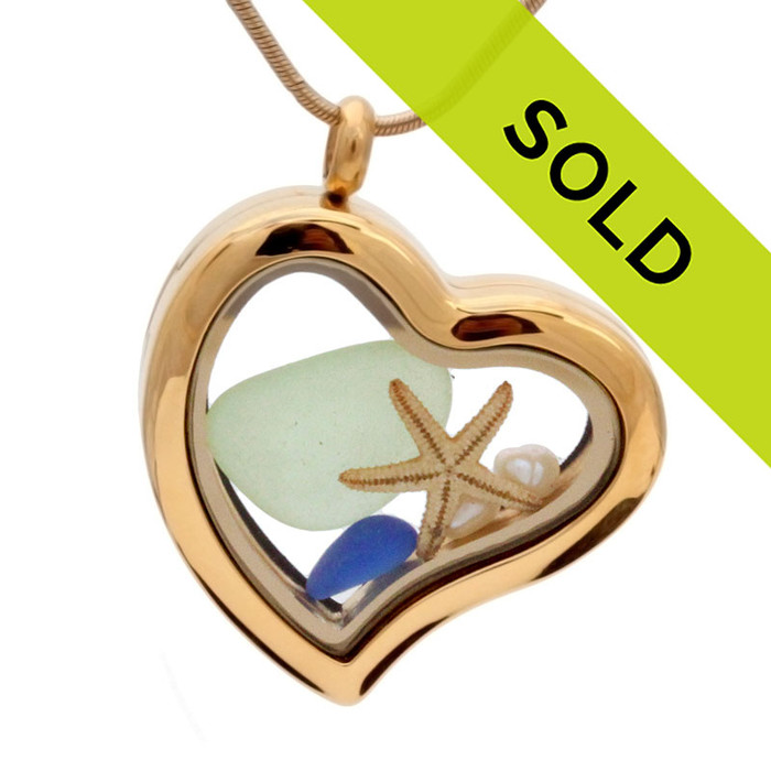 A stunning goldtone stainless steel locket necklace with blue and seafoam green sea glass, pearls and a real starfish.
Sorry this sea glass jewelry item has been sold!