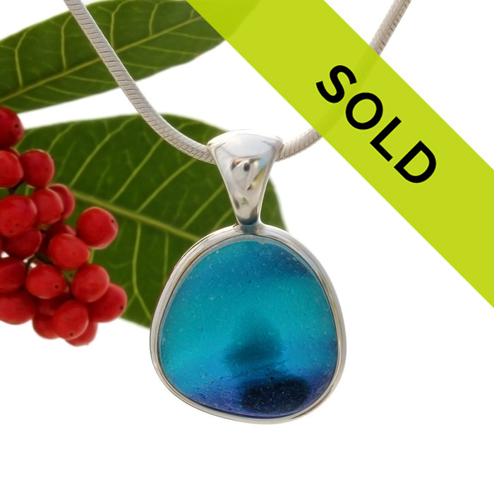 This sea glass is fused vivid teal, purple and aqua bright blue inside a base of  pure white.  It is set in our  sterling silver Deluxe Wire Bezel© setting. Very Versatile and elegant. CLASSIC!
Sorry this one of a kind sea glass necklace pendant has been sold!