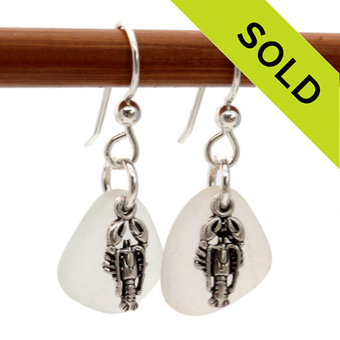 Airy and light pure white sea glass earrings in sterling with sterling lobster charms.