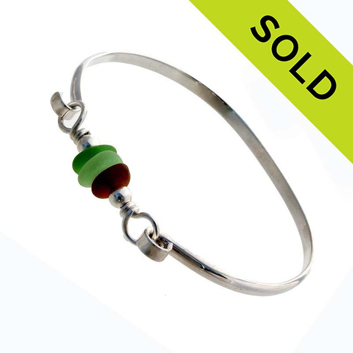 Three pieces of beach found sea glass on a solid sterling half round bangle bracelet.
SOLD - Sorry this Sea Glass Bracelet is NO LONGER AVAILABLE!