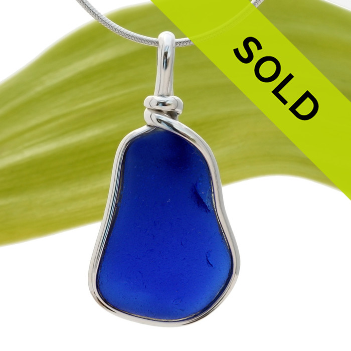 A nice piece of Cobalt Blue with in our signature Original Wire Bezel© pendant setting that leaves both front and back open and the glass unaltered from the way it was found on the beach.
Sorry this piece has been sold!