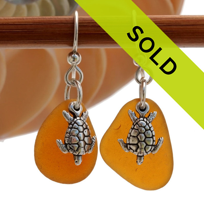 Genuine Sea Glass Earrings in Amber Brown With Solid Sterling Starfish Charms
These are 2 perfect TOP QUALITY pieces of perfect amber Certified Genuine Sea Glass in a simple sterling setting with Solid Sterling Silver sea turtle charms. 
Sorry this sea glass jewelry selection has been sold!