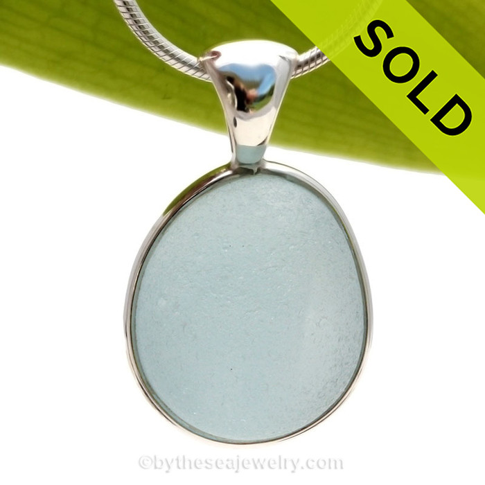 A wonderful shaped thick piece of vivid baby Blue sea glass in our In Our Deluxe Sterling Wire Bezel© necklace pendant.
Sorry this piece of Sea Glass Jewelry has been sold!