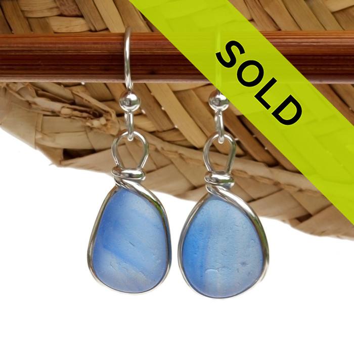 A great match in my English Multi Sea Glass Earrings in a vivid cross sectioned Carolina Blue set in our Original Wire Bezel© setting in silver.

Much sea glass from this region is flashed, meaning color is only on on side, These pieces are a solid Carolina Blue with streaks of darker blue color running inside the sea glass.  ULTRA ULTRA RARE! 
Sorry these sea glass earrings have been sold!