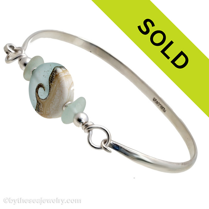 Two pieces of beach found sea glass in delicate seafoam green on this solid sterling silver half round sea glass bangle bracelet. 
Sorry this sea glass jewelry piece has been sold!