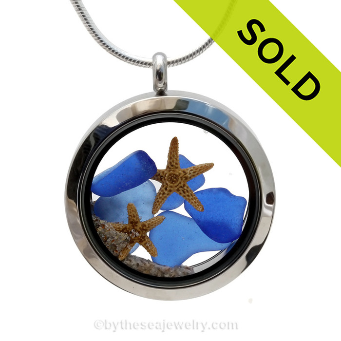 A beautiful pieces of natural blue sea glass combined in a stainless steel locket necklace with a two real starfish and beach sand.
Sorry this sea glass locket has been SOLD!