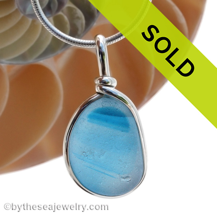 A stunning piece of electric aqua English Multi sea glass set for a necklace in our Original Sea Glass Bezel© in solid sterling silver setting.
Streaks of a darker aqua hue run inside the glass making it real ultra rare piece.
Sorry this piece of sea glass jewelry has been sold!