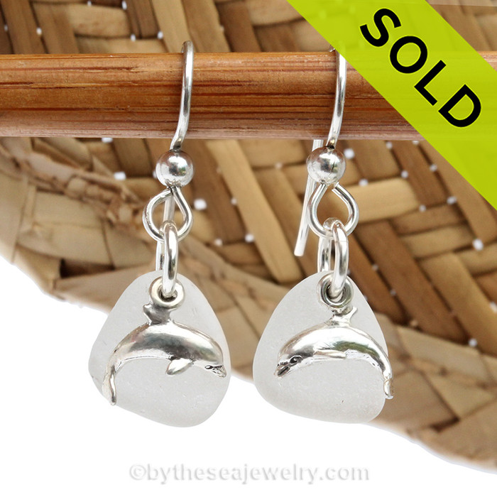 Beach found white sea glass pieces with solid sterling sea dolphin charms. 
Sorry these Sea Glass Earrings have been SOLD!