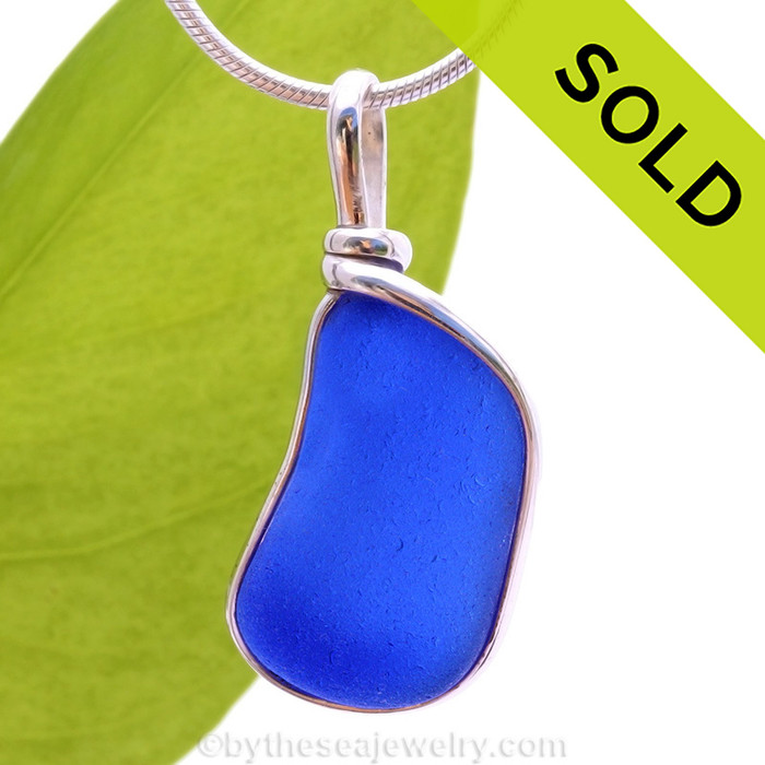 A curvy piece of Cobalt Blue Genuine Sea Glass with in our signature Original Wire Bezel© pendant setting.
Sorry this Sea Glass Pendant has been SOLD!