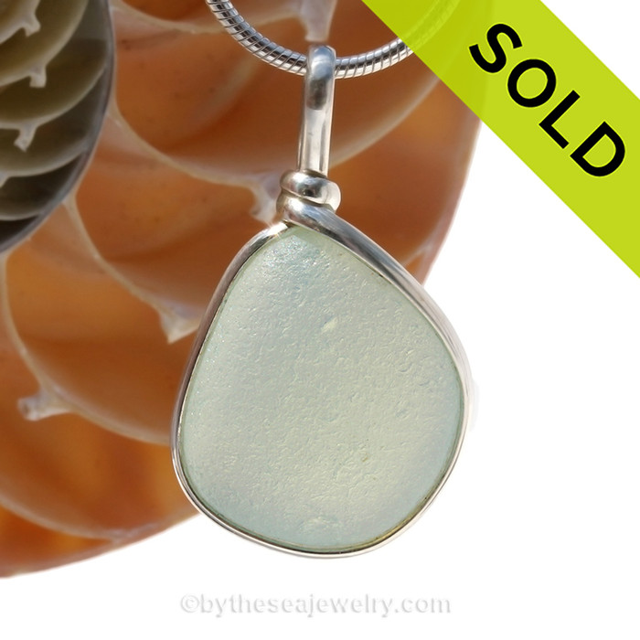 SOLD - Sorry This Sea Glass Jewelry Selection Is NO LONGER AVAILABLE!
A stunning piece opalized sea glass set in our Original Wire Bezel© pendant setting. This picture does not do the piece justice. In natural light, this piece will really GLOW a pale yellow and luminous pink and bluish glow.