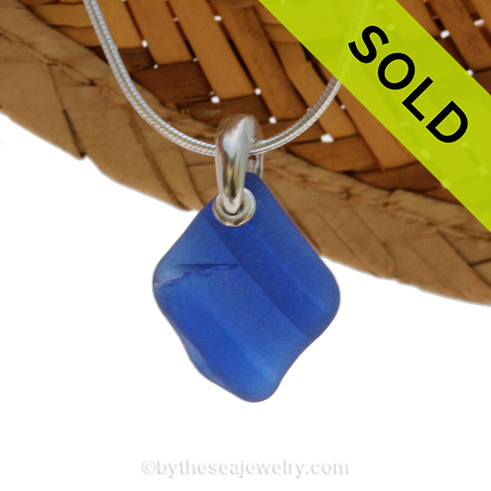 A neat  piece of ridged blue sea glass is combined on a solid sterling cast bail and presented on an 18 Inch solid sterling snake necklace chain.
Sorry this Sea Glass Necklace has been SOLD!