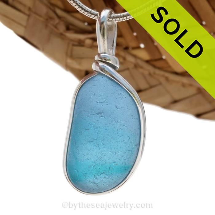 A STUNNING piece of beach found glass from Seaham England in a BRILLIANT MIXED BLUE & AQUA is set in our Original Wire Bezel© pendant setting.
Sorry this Sea Glass Jewelry selection has been SOLD!