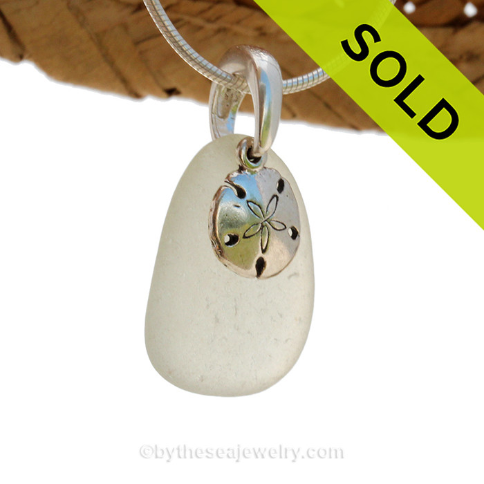 A perfect piece of natural beach found pale green sea glass is combined with a solid sandollar charm and presented on an 18 Inch solid sterling snake chain.
Sorry this Sea Glass Necklace has been SOLD!