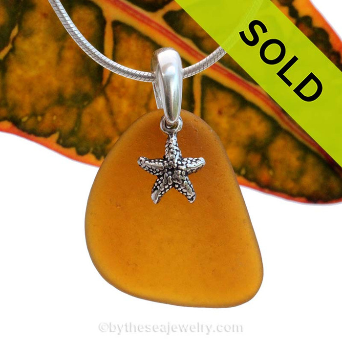 A perfect piece of natural beach found amber brown sea glass is combined with a solid starfish charm and presented on an 18 Inch solid sterling snake chain.
Sorry this Sea Glass Jewelry selection has been SOLD!