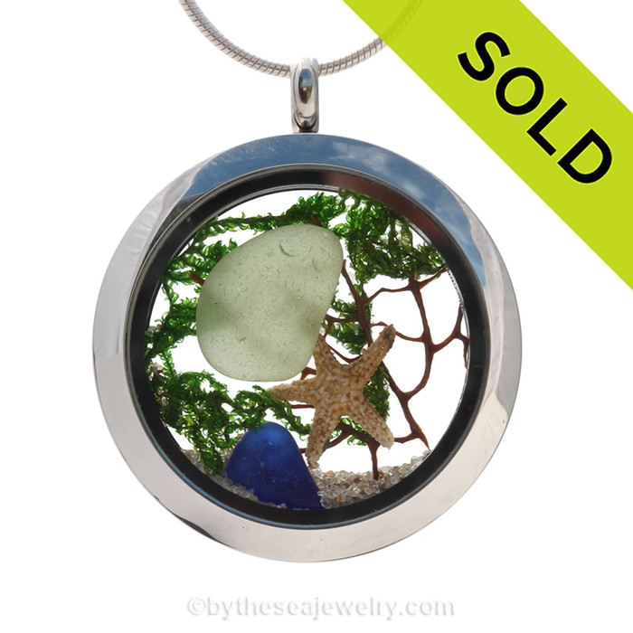 A beautiful sliver of natural blue  and seafoam green sea glass combined in a stainless steel locket necklace a real starfish and beach sand.
SOLD - Sorry this Sea Glass Locket is NO LONGER AVAILABLE!