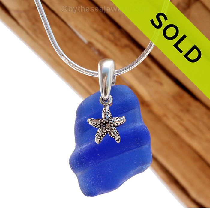 A neat  piece of ridged blue sea glass and starfish charm on a solid sterling cast bail and presented on an 18 Inch solid sterling snake necklace chain.
Sorry this Sea Glass Necklace has been SOLD!