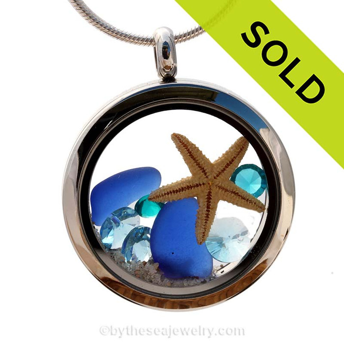 Beautiful pieces of natural Cobalt Blue sea glass combined in a stainless steel locket necklace with a real starfish & Zircon & Turquoise crystal Gems.
Sorry this sea glass locket has been sold!