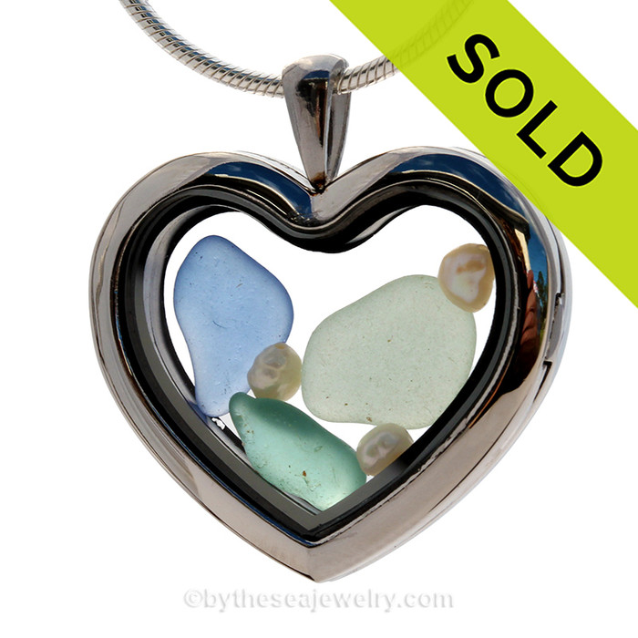 Beautiful pieces of seafoam, aqua and Carolina blue sea glass pieces combined with fresh water pearls in this stainless steel heart locket.
SOLD - Sorry This Sea Glass Jewelry Selection Is NO LONGER AVAILABLE!