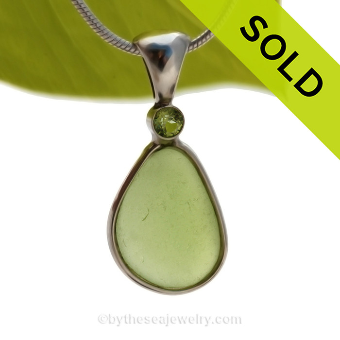 This beautiful Bright Peridot Green sea glass piece is set in our Deluxe Wire Bezel© pendant setting with a genuine Peridot gem.
SOLD - Sorry this Rare Sea Glass Pendant is NO LONGER AVAILABLE!