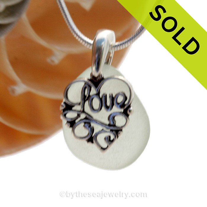 A nice smaller piece of bright seafoam green genuine sea glass with a solid sterling bail and detailed "Love" heart charm.
This piece comes complete with our sterling 1MM snake chain.
SOLD - Sorry this Sea Glass Necklace is NO LONGER AVAILABLE!
