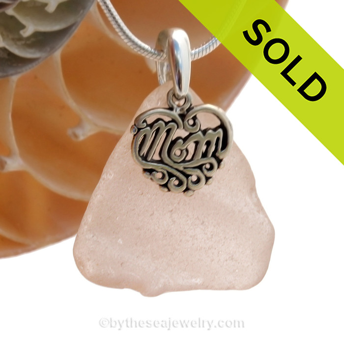 Not Perfect (but who is) piece of Depression Era Pink or Peach genuine sea glass with a solid sterling bail and MOM charm. This piece comes complete with our sterling 1.3MM snake chain.
SOLD - Sorry this  Rare Sea Glass Necklace is NO LONGER AVAILABLE!
