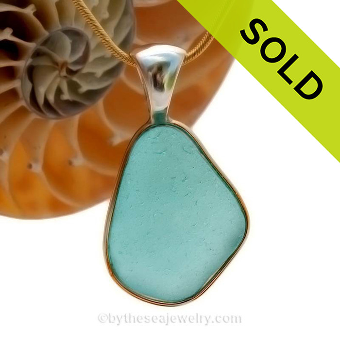 This is a beautiful LARGE P-E-R-F-E-C-T Vivid Bright Aqua Blue Sea Glass set in our Mixed Deluxe Tiffany Wire Bezel© pendant setting. This is our Deluxe Wire design that leaves the glass UNALTERED from the way it was found on the beach.
SOLD - Sorry this Rare Sea Glass Pendant is NO LONGER AVAILABLE!