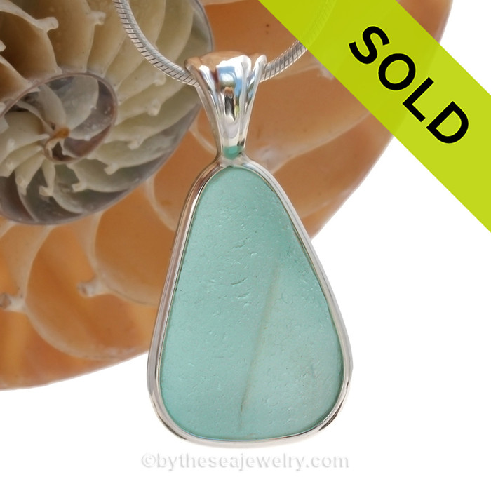 A wonderful PERFECT shaped and embossed piece of Vivid Aqua Genuine Sea Glass in our In Our Deluxe Sterling Wire Bezel© Necklace Pendant.
SOLD - Sorry this Rare Sea Glass Pendant is NO LONGER AVAILABLE!