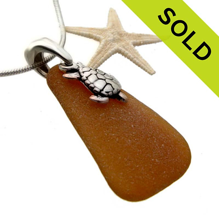 A perfect triangle of amber brown sea glass set on a cast solid sterling silver bail with a sterling sea turtle charm.
SOLD - Sorry this Sea Glass Necklace is NO LONGER AVAILABLE!