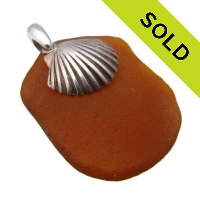 Simple and beachy this Certified Genuine amber brown sea glass pendant is complimented by a LARGE solid sterling silver top quality Sea Shell charm.
SOLD - Sorry this Sea Glass Pendant is NO LONGER AVAILABLE!