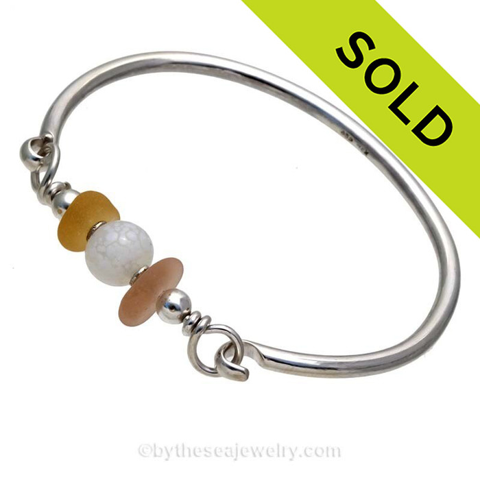 Ultra Rare Gold and Depression Pink Genuine Sea Glass Bangle Bracelet set with a vintage Opalized Bead and finished in sterling details on a Solid Sterling Round Bangle Bracelet.
SOLD - Sorry this Sea Glass Jewelry selection is NO LONGER AVAILABLE!