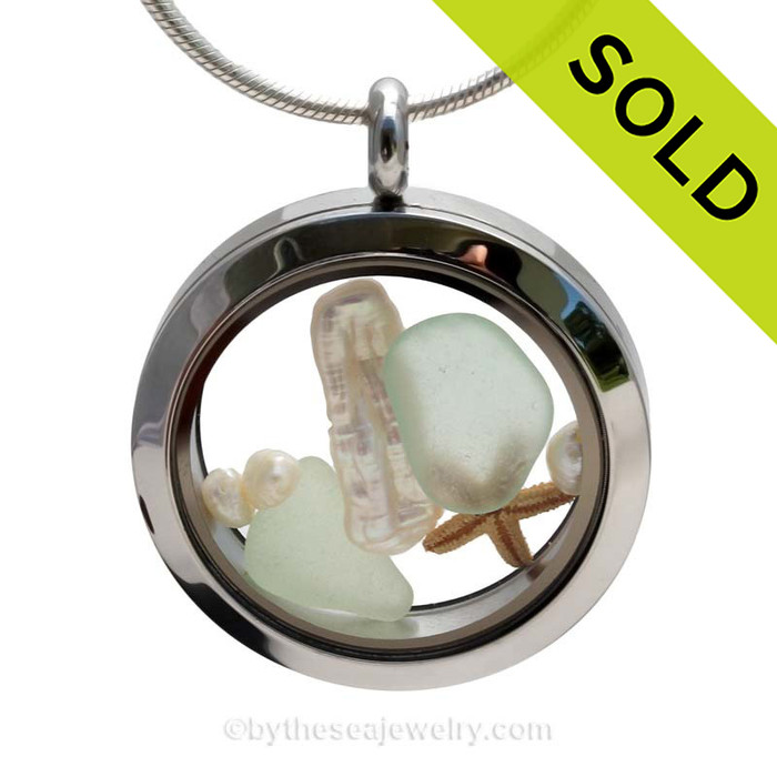 Genuine Seafoam sea glass pieces combined with a real baby genuine pearls and a tiny starfishin this stainless steel locket.
SOLD - Sorry this Sea Glass Locket is NO LONGER AVAILABLE!