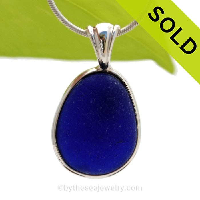 A stunning thick piece of genuine UNALTERED sea glass in an elegant setting.A perfect and LARGE piece of vivid Midnight Blue sea glass from the UK in our In Deluxe Sterling Wire Bezel© Setting that leaves the glass just the way it was found on the beach. 

SOLD - Sorry this Rare Sea Glass Pendant is NO LONGER AVAILABLE!