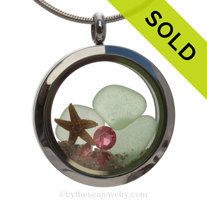 Genuine pastel seafoam sea glass pieces combined with a real starfish and crystal Pink tourmaline gems stainless steel locket. Finished in real beach sand for you own personal beach on the go!
SOLD - Sorry this Sea Glass Locket is NO LONGER AVAILABLE!