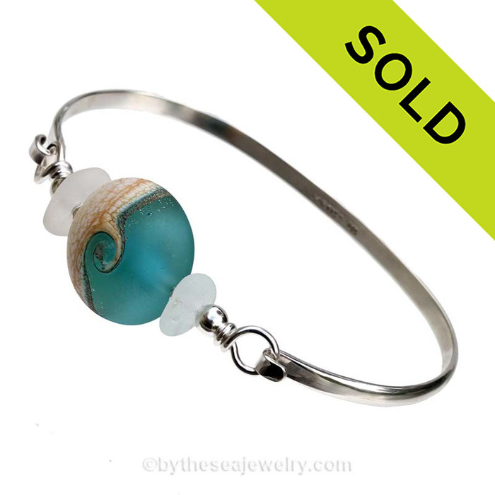 Pure White Genuine Sea Glass Bangle Bracelet set with a handmade Vivid Aqua lampwork glass wave bead set with sterling details on a solid sterling round bangle bracelet.