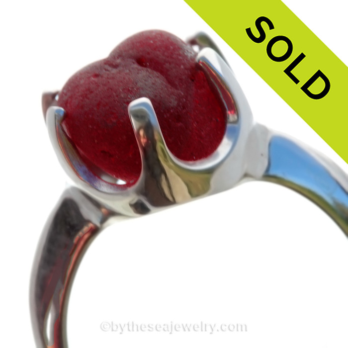 A stunning piece of PERFECT VIVID mixed Deep Red Victorian Era vivid sea glass set in a secure solid sterling 6 prong ring.