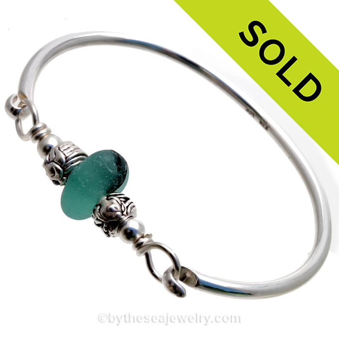 A beautiful Stunning and Thick and Round Deep Mixed Aqua Green sea glass combined Sterling Silver Fish Beads on a Solid Sterling Premium Round Bangle Bracelet.
This is a small to Medium bangle at 7 inches but can be sized down upon request.
Simply put size needed in comments section and we will resize and ship the same day
