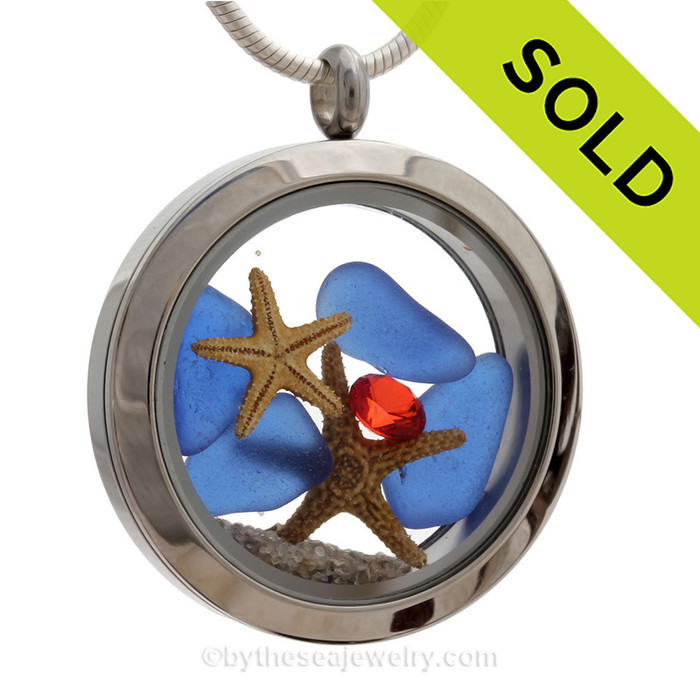 Cobalt Blue Sea Glass in a crystal and stainless steel locket combined with a baby starfish and crystal gems.  
SOLD - Sorry This Sea Glass Locket is NO LONGER AVAILABLE!