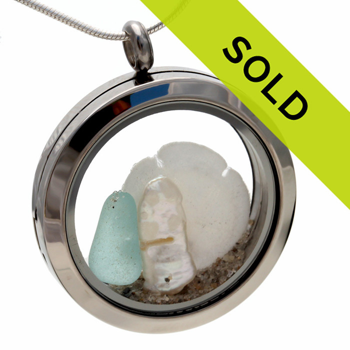 Aqua sea glass locket necklace with stick pearl and sandollar.
Your own personal beach on the go!