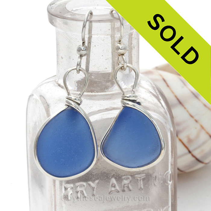 Large saturated medium blue sea glass pieces from Seaham England are set in our Original Wire Bezel© earring setting. These two pieces are large enough to be two pendants.