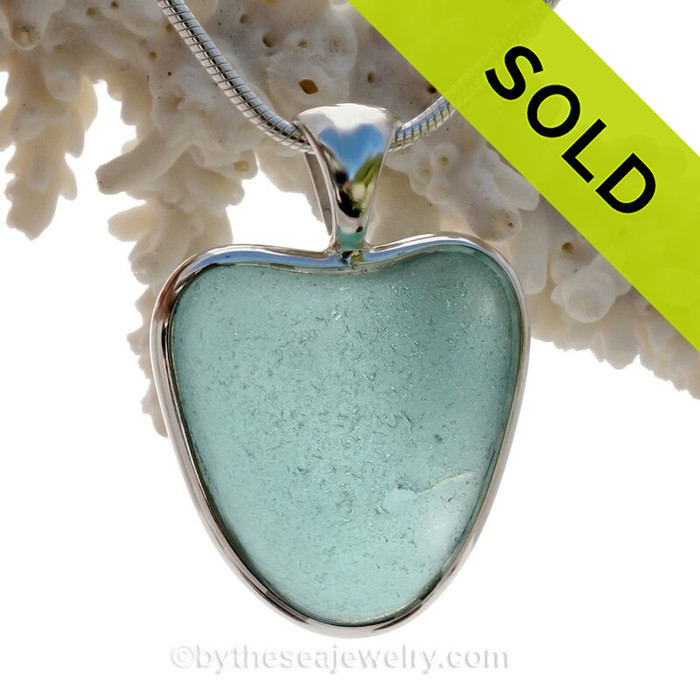 A beautiful stunning Aqua Blue natural Sea Glass Heart Pendant set in our Deluxe Wire Bezel© setting in Solid Sterling Silver.