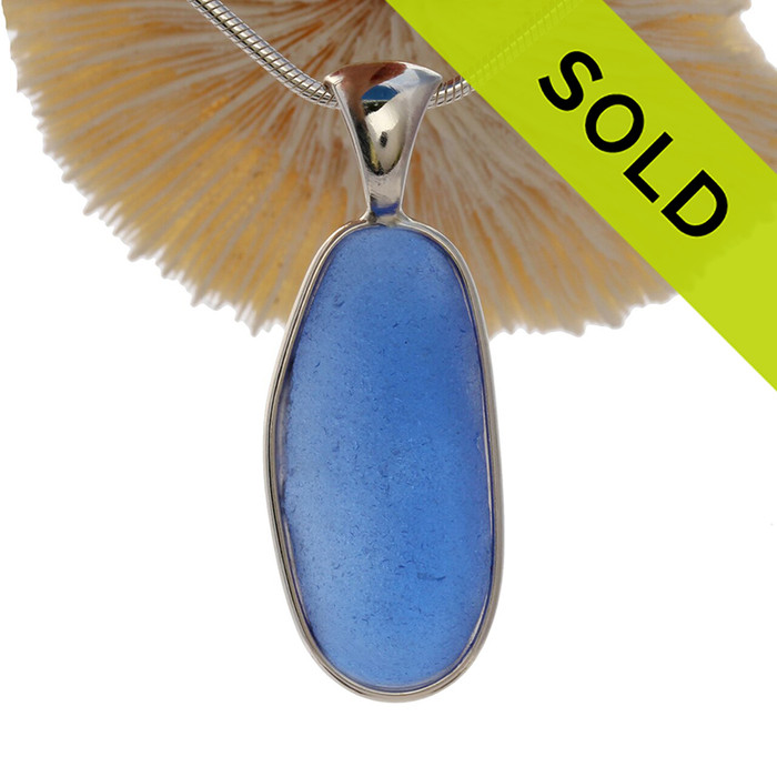 P-E-R-F-E-C-T Long Large Bright Blue Sea Glass In a Solid Sterling Silver Wire Bezel© Necklace Pendant.
A great piece if you are fond of wearing denim.