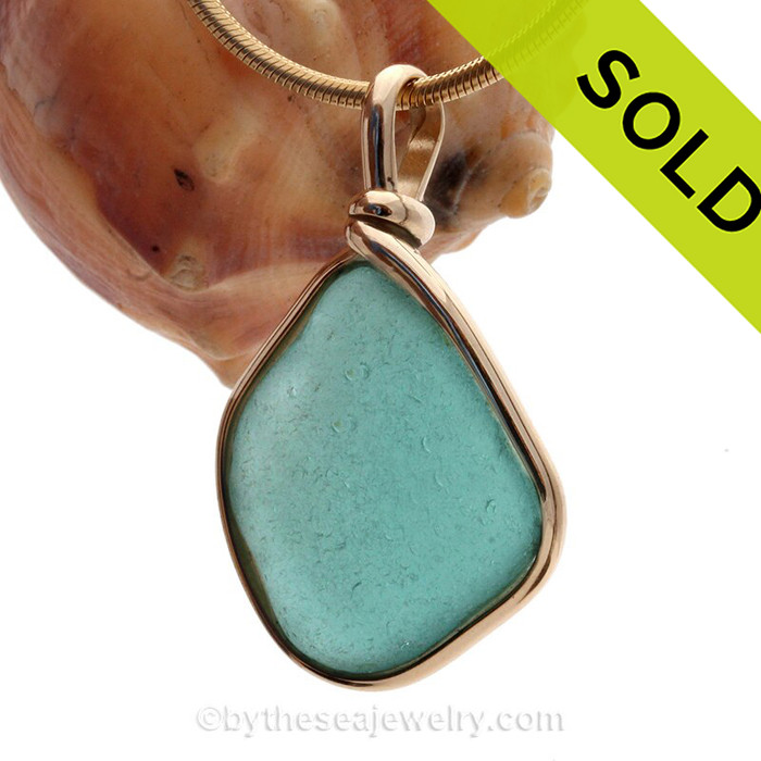 A Stunning Deep Aqua Blue Genuine Sea Glass set in our Original Wire Bezel© pendant setting in 14K Rolled Gold.