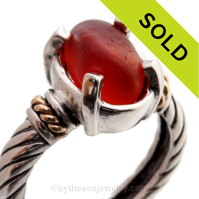 A lovely chunky piece of all natural Amberina or Orange Red sea glass in a beautiful sterling silver ring setting with 14K gold accents.