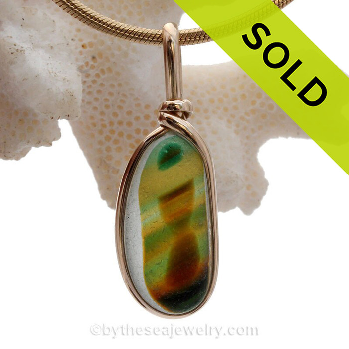 A stunning combination of vivid mixed vivid green with a touch of bright gold and amber in this very old English Sea Glass piece and set in our Original Wire Bezel© necklace pendant setting.