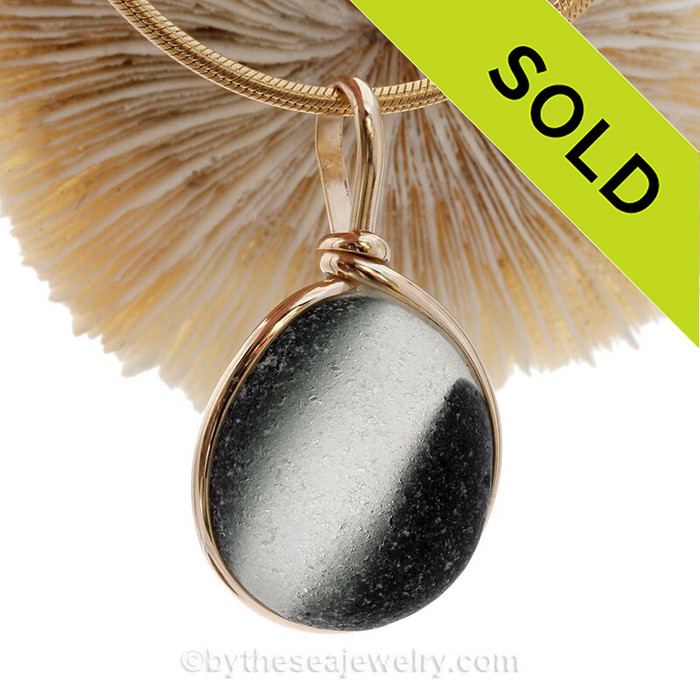 A large perfectly round mixed Black Green Seaham Sea Glass Pendant in our Original Wire Bezel© setting in 14K Goldfilled
A stunning and unusual piece.