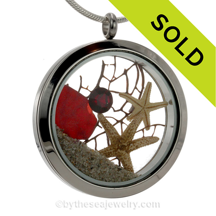 Ruby Red Real sea glass pieces combined with a two starfish, a ruby red gem and real beach sand in this JUMBO 35MM stainless steel locket.
SOLD - Sorry this Sea Glass Jewelry selection is NO LONGER AVAILABLE!